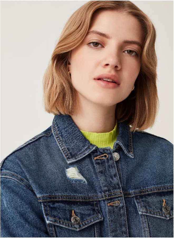او في اس Denim jacket with abrasions