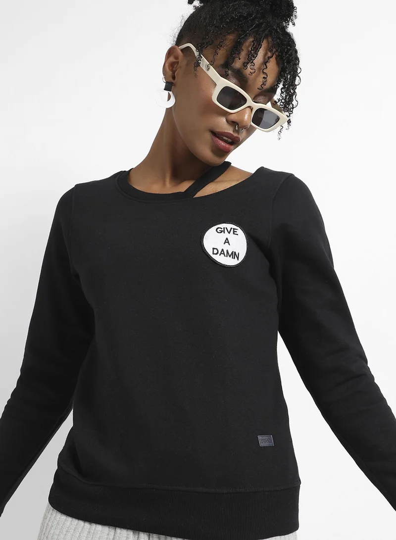 Campus Sutra Women's Black Give A Damn Hoodie With Cut-Out Detail For Casual Wear | Asymetrical Neck  | Long Sleeve | Pull On Closure | Cotton Sweatshirt Crafted With Comfort Fit For Everyday Wear