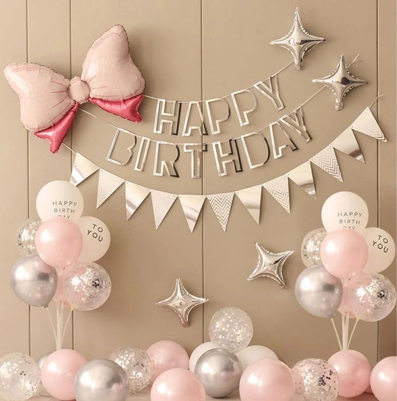 A set of 36 birthday decorations that includes a bow-shaped foil balloon, latex balloons in pink and white, a “Happy Birthday” banner, and a silver-colored pennant banner. - Image 1