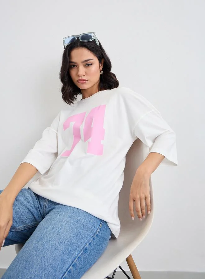 Styli Styli Women Off White Exaggerated Shoulder Graphic Oversized T-Shirt