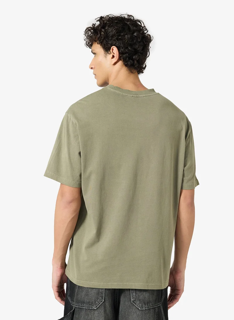 كارل كاني تيشيرت بوكسي بتصميم خط سماء مميز مغسول