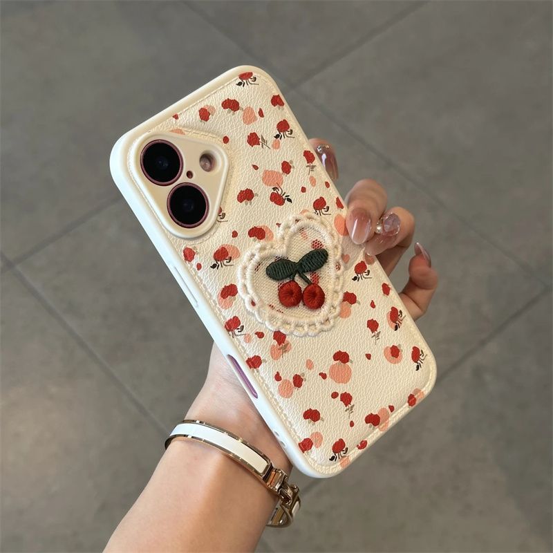 Apple iPhone 17 case with 3D embroidered plush heart and cherry cartoon design, featuring a shockproof leather case