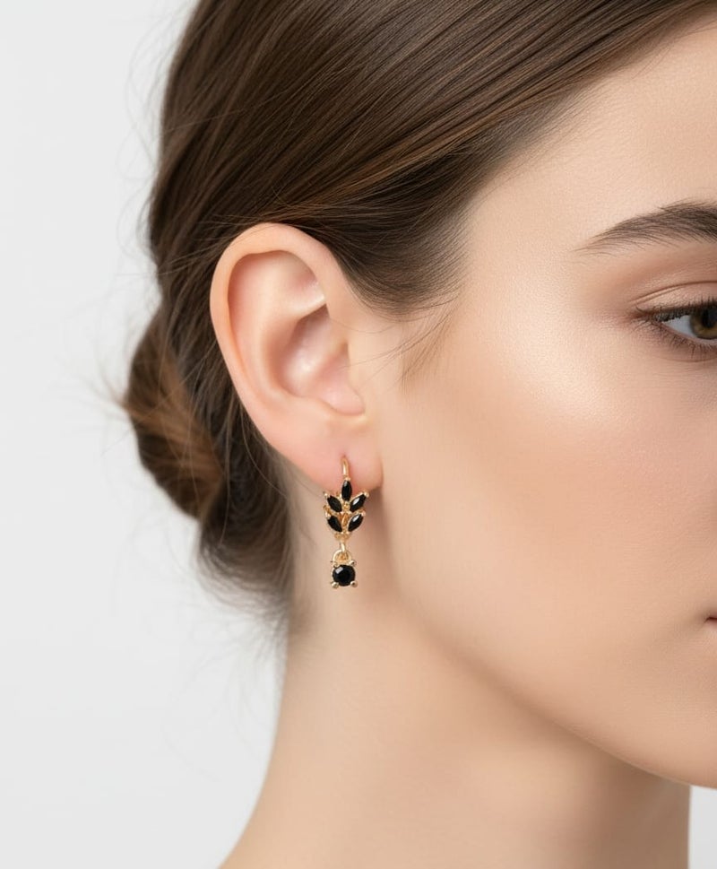 A delicate gold-plated hoop featuring a leaf design studded with black stones, topped with an elegant square-shaped pendant in luxurious black. - Image 2