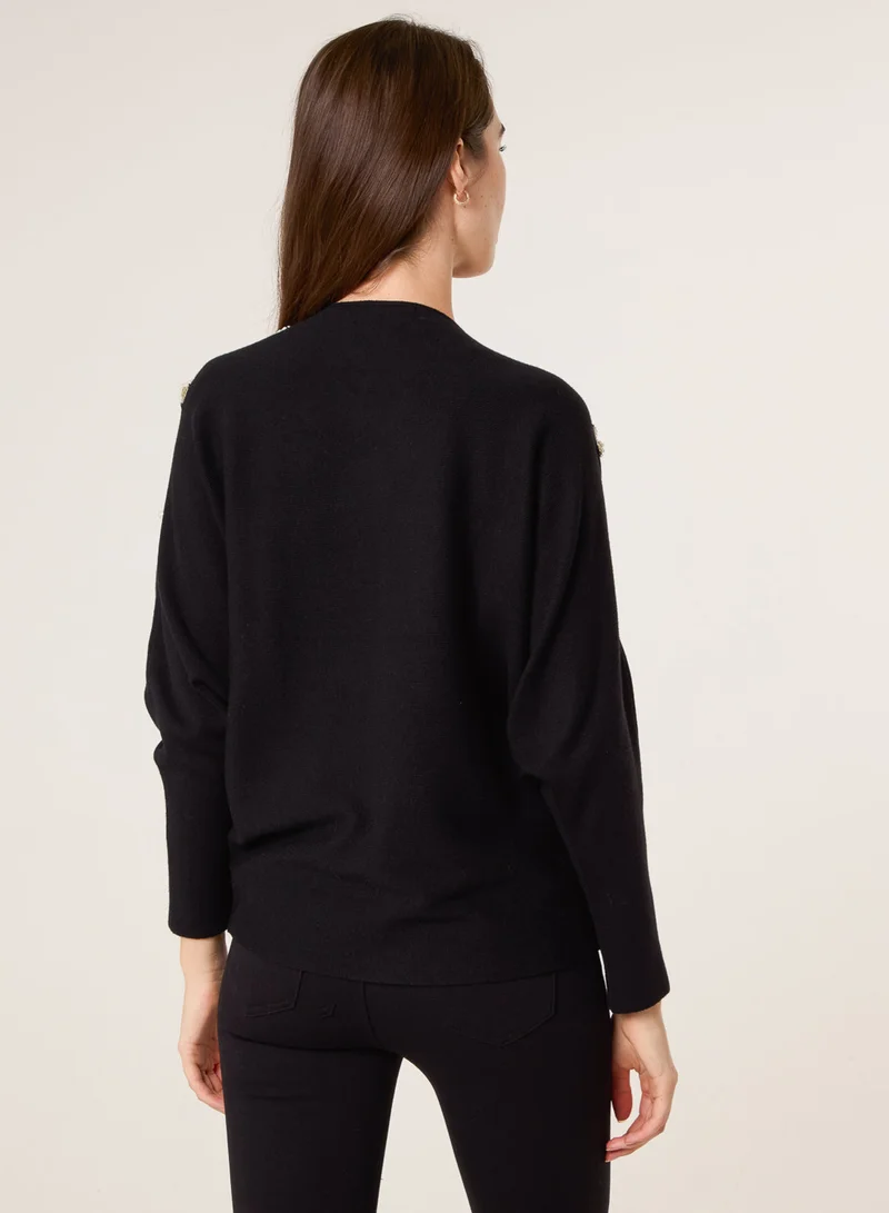 بلو فانيلا كنزة بياقة على شكل حرف  وأكمام خفاش وتفاصيل لؤلؤ