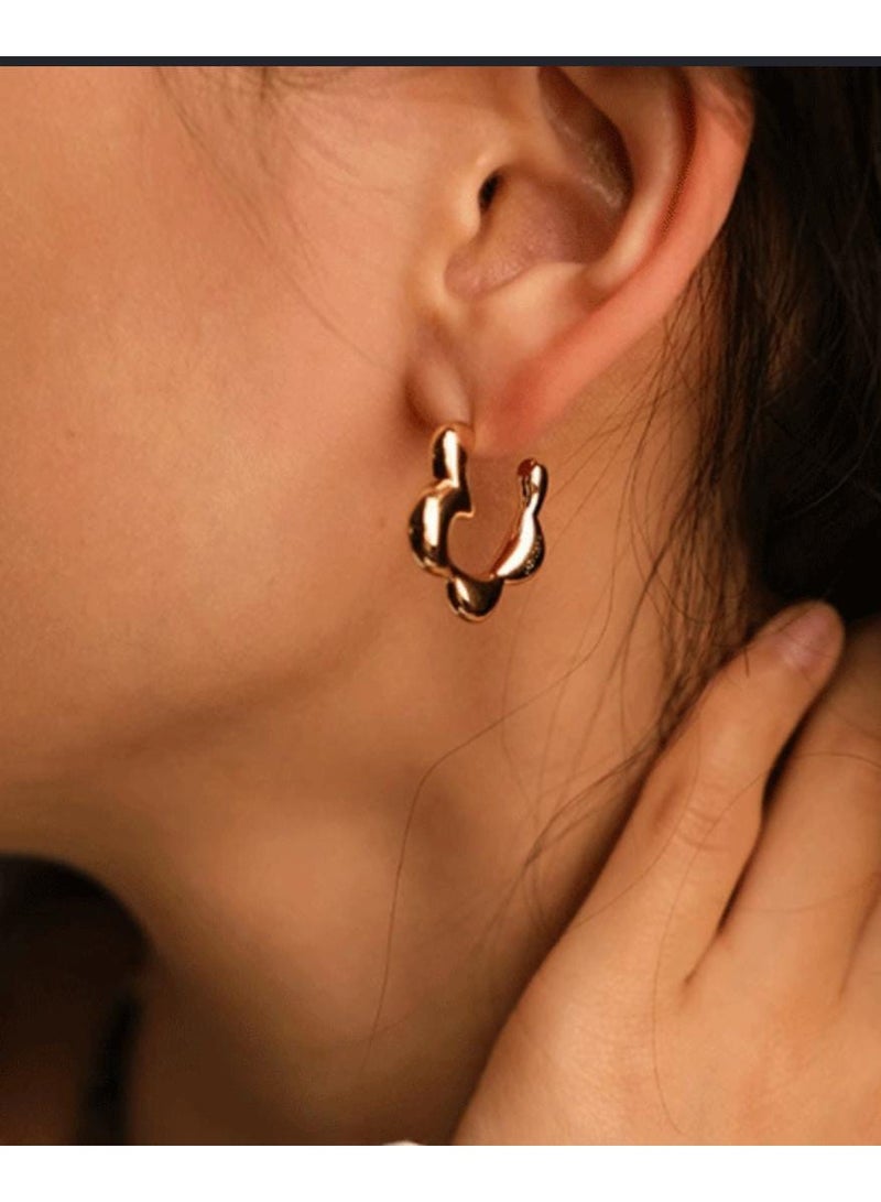 Luxuria These gold women's earrings feature a unique, wavy design resembling a melting flower, adding a touch of modern elegance. - Image 3