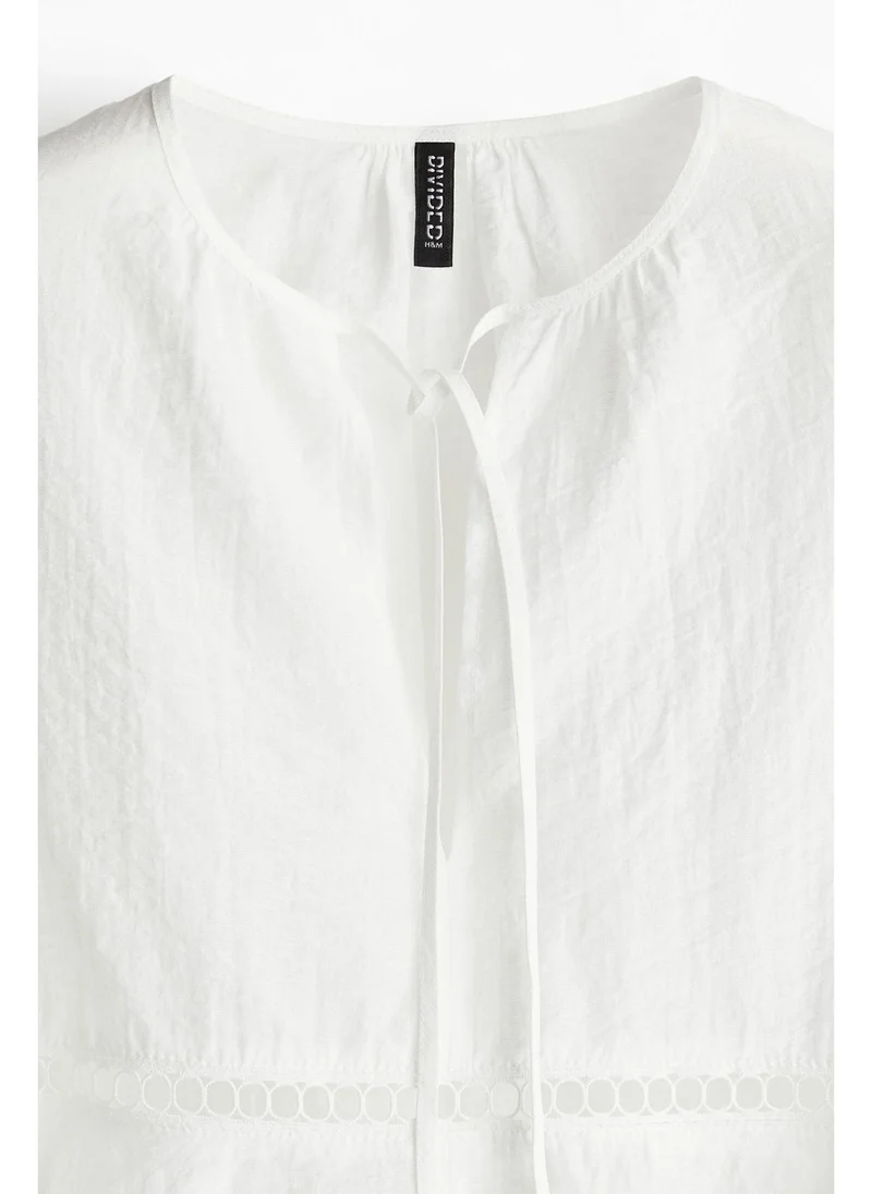 H&M Oversized lace-inset blouse