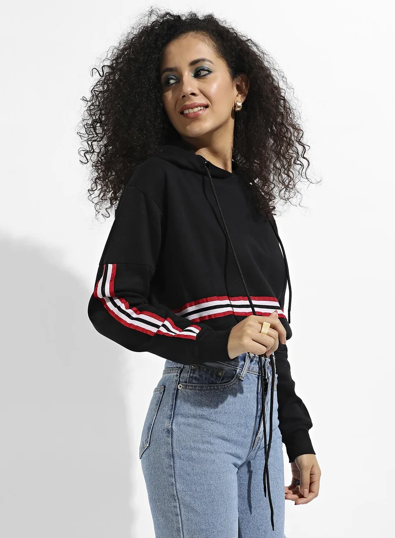 Campus Sutra Women's Black Tie-Up Waist Hoodie With Contrast Striped Sleeves