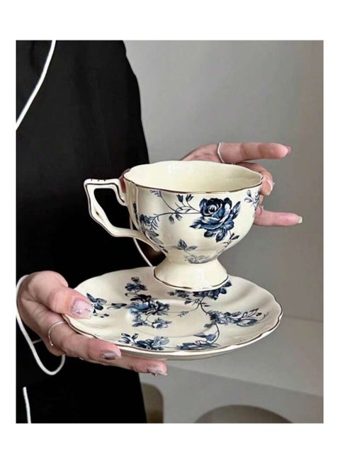 Coffee cup and saucer decorated with navy blue flowers made of ceramic