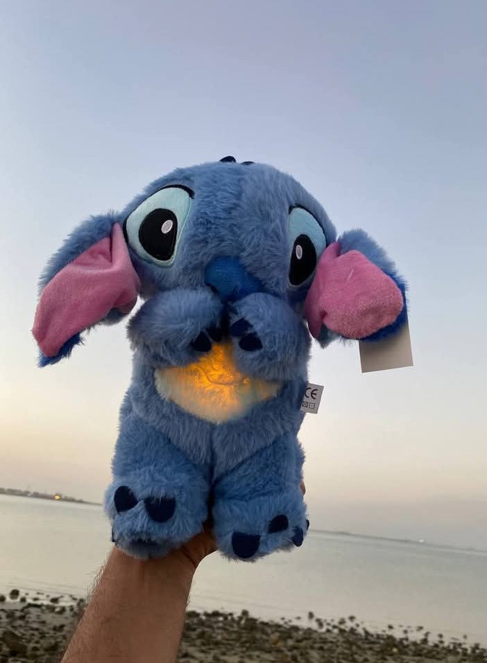Stitch breathing teddy bear is equipped with music and lights and works by pressing his leg