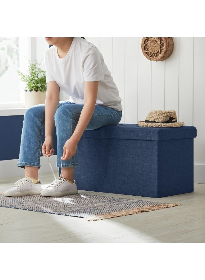 SONGMICS 30 Inches Folding Storage Ottoman Bench, Storage Chest, Foot Rest Stool, Navy Blue  - Image 1