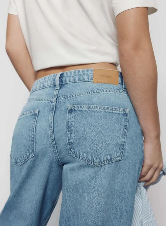 Springfield  High-waisted jeans with front and back pockets, button and zip fastening fastening , and a wide, straight leg. These jeans feature a washing process using cutting-edge technologies, reducing water, chemical, and energy consumption. for Women | Best Price UAE