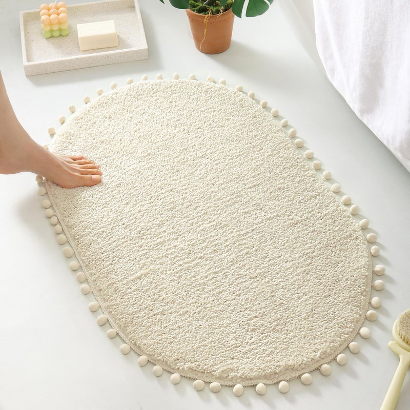 YIRDDEO Oval Bathroom Rugs Beige Rug with Pom Cream Bath Mat for Bedroom Non Slip Cute Boho Absorbent Mats Soft Plush Washable Rug (20x30 inches) - Image 1