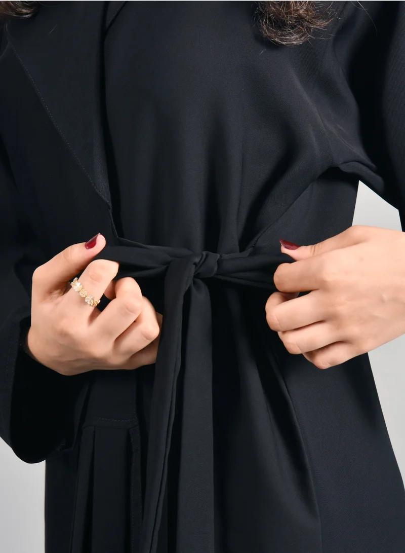 HAWRAA ABAYA Formal black wrap abaya with tie closure and pleats at the bottom