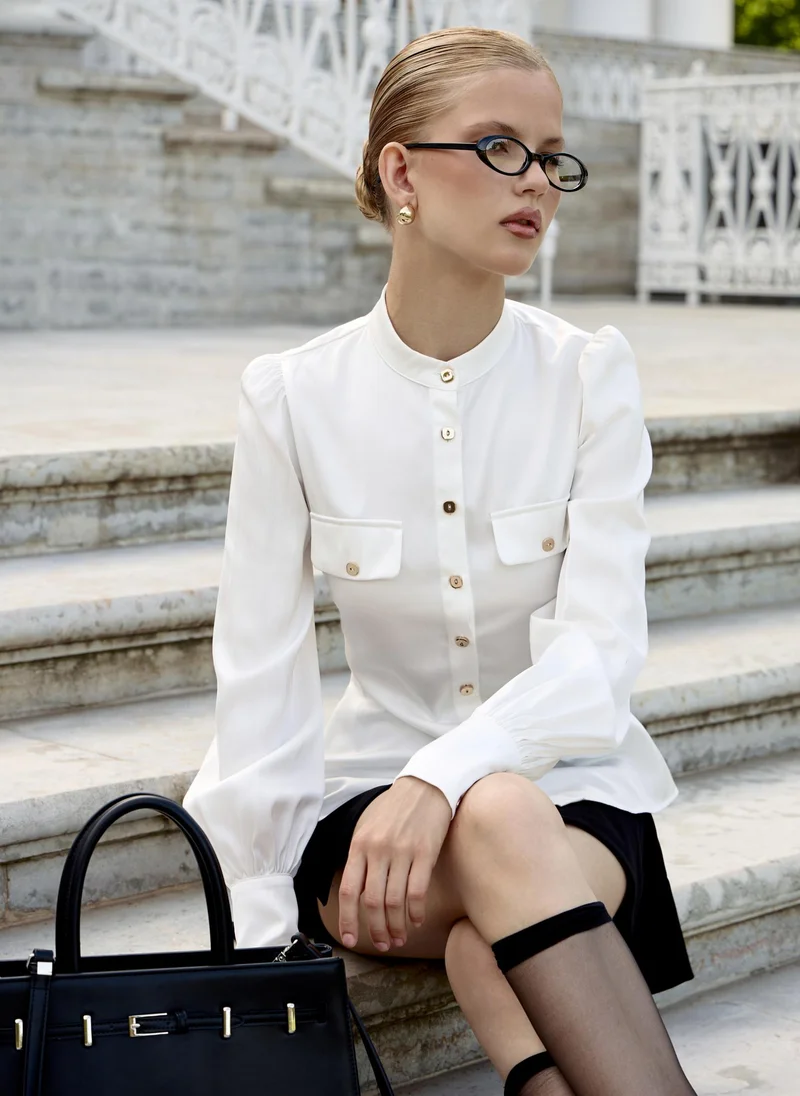 ليتشي قميص بأكمام واسعة وأزرار معدنية