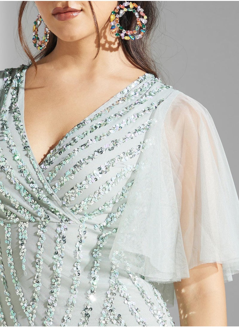 نمشي x فستان مزين بترتر واكمام كشكش  - Image 4