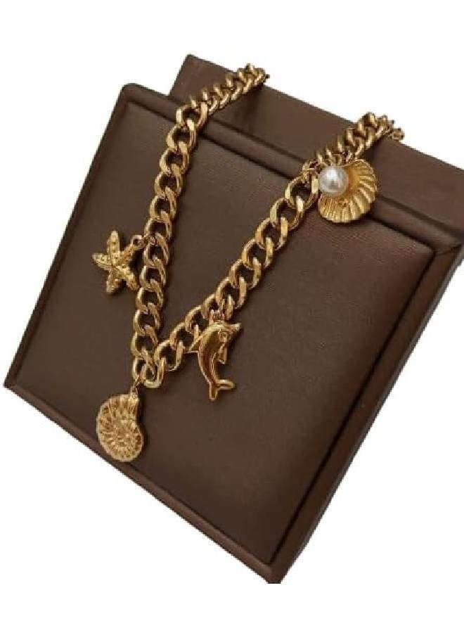 Thick gold metal pendant with gold chain attached in the shape of a dolphin star - Image 1