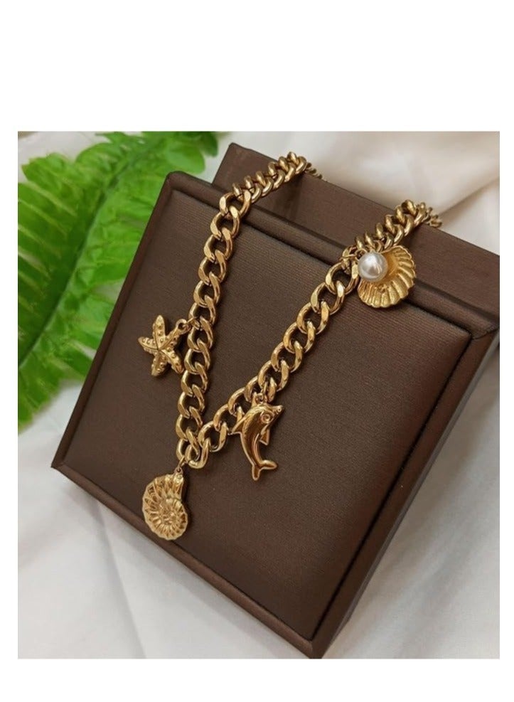 Thick gold metal pendant with gold chain attached in the shape of a dolphin star - Image 2