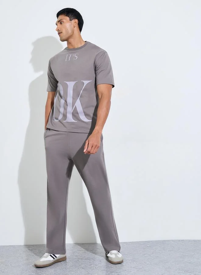 Styli Men Slogan Print Oversized T-Shirt and Joggers Set