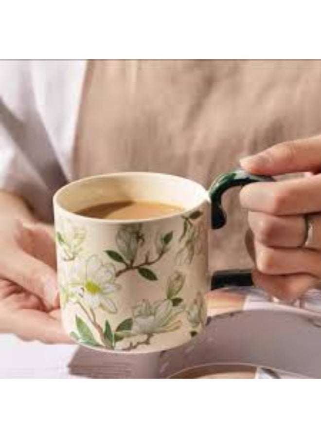 A luxurious ceramic mug with a magnolia flower pattern and a comfortable, colorful handle for coffee and tea. - Image 1