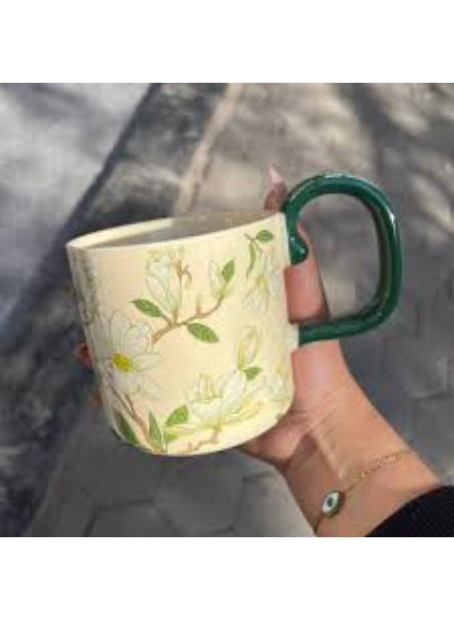 A luxurious ceramic mug with a magnolia flower pattern and a comfortable, colorful handle for coffee and tea. - Image 2