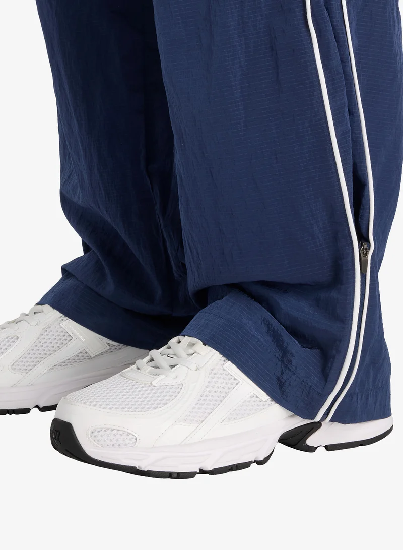 New Balance Essentia Legacy Woven Pants