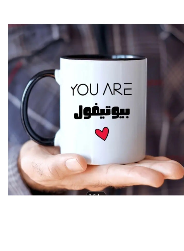 راين كوب قهوة سيراميكي باللون الأسود مكتوب عليه "أنتِ جميلة" - Image 1