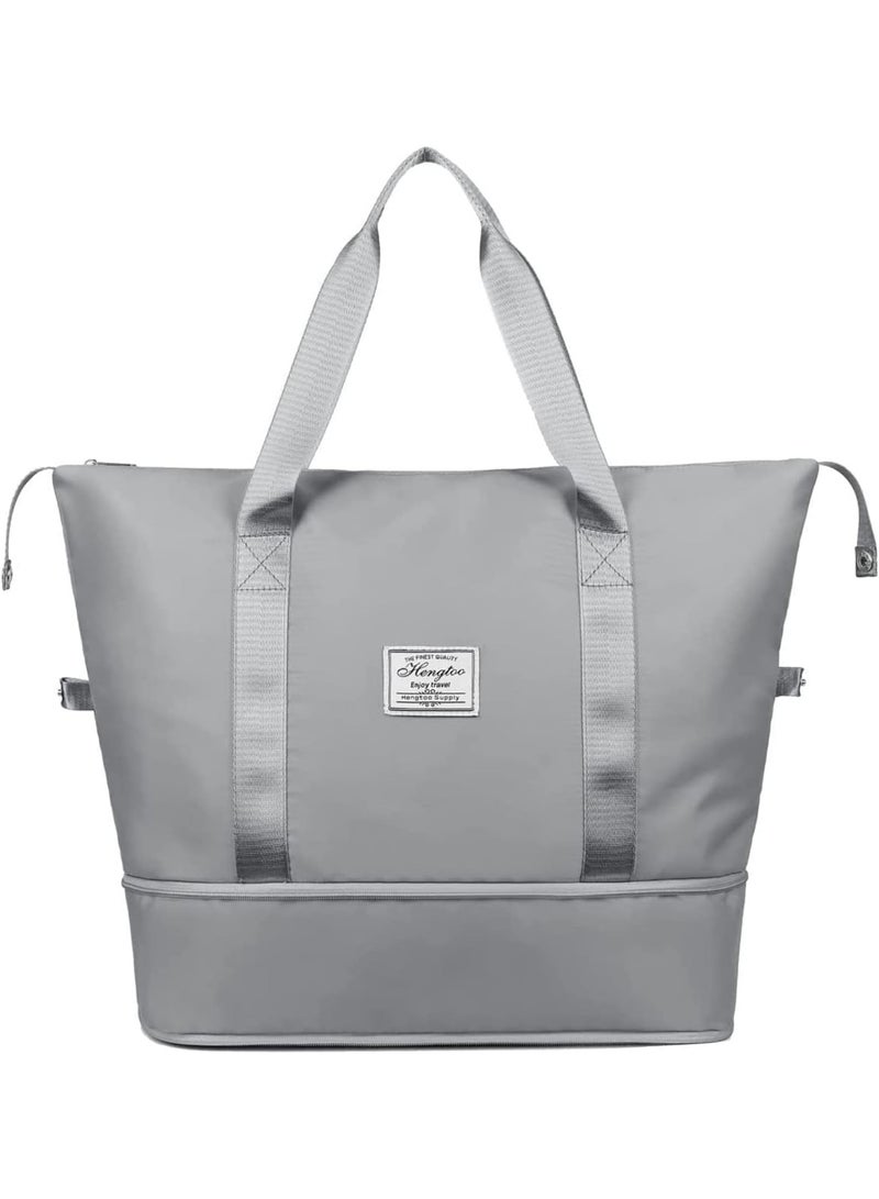 A multi-purpose bag that folds easily, features a front pocket and a top zipper, and can be attached to the handle of a suitcase. Designed to combine style, comfort, and practicality, this bag is available in gray. - Image 1