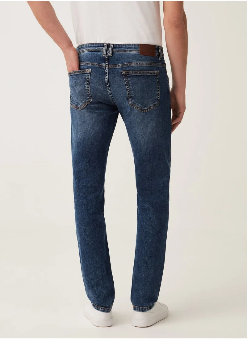 او في اس Faded, slim-fit stretch jeans