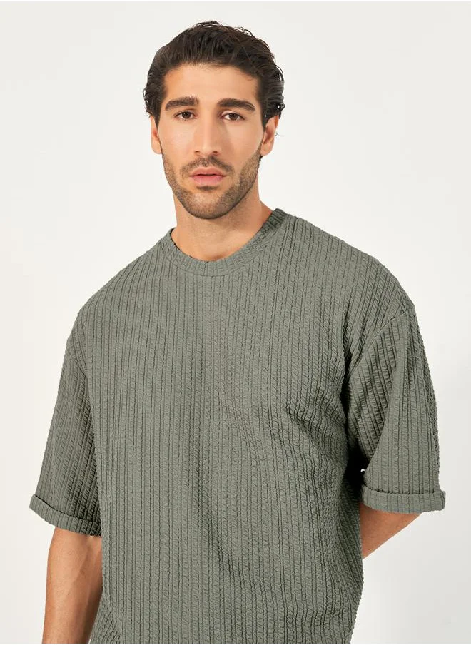 Styli Seersucker Textured Knit Boxy Fitted T-Shirt with Turn-Up Sleeves