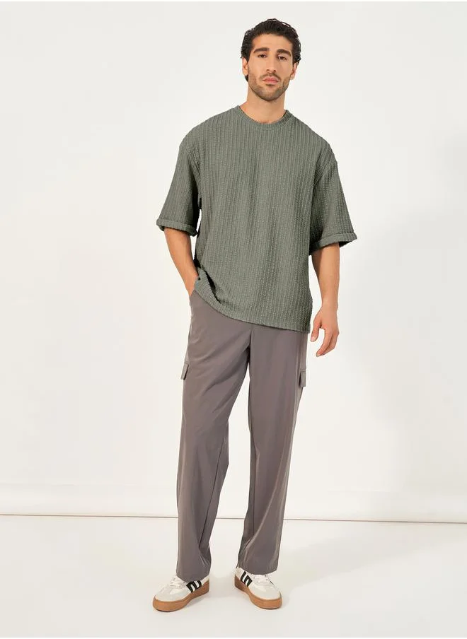 Styli Seersucker Textured Knit Boxy Fitted T-Shirt with Turn-Up Sleeves