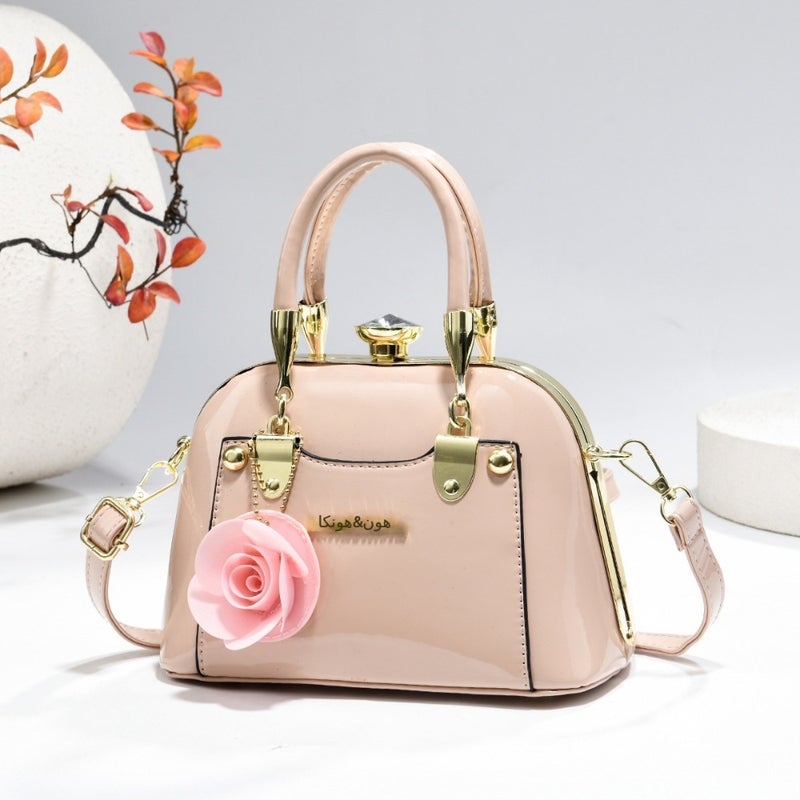Steel armor mini shell bag, suitable for casual fashion, shiny surface, equipped with floral charm pendant, multi-functional handbag or cross-body bag, fashionable classic, lightweight and durable design
