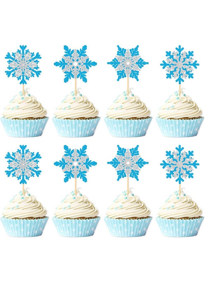 مجموعة تزيين كعك مكونة من 16 قطعة، زينة كعك لامعة لفصل الشتاء، أغطية كب كيك على شكل ندفة ثلج مزدوجة الطبقات باللونين الفضي والأزرق بموضوع شتوي، لوازم تزيين الكيك لحفلات استحمام الأطفال وأعياد ميلاد الأطفال - Image 1
