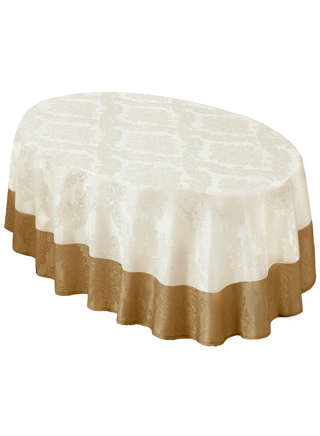 Newbridge Valencia Two Tone Bordered Damask Fabric Tablecloth, Wrinkle and Stain Resistant Fine Dining Holiday Hotel Quality Tablecloth, 60 Inch x 84 Inch Oval, Antique Ivory/Gold - Image 1