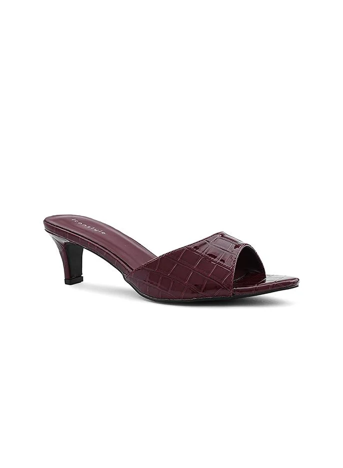 أيقون Glamorous heel slipper with a shimmering surface.