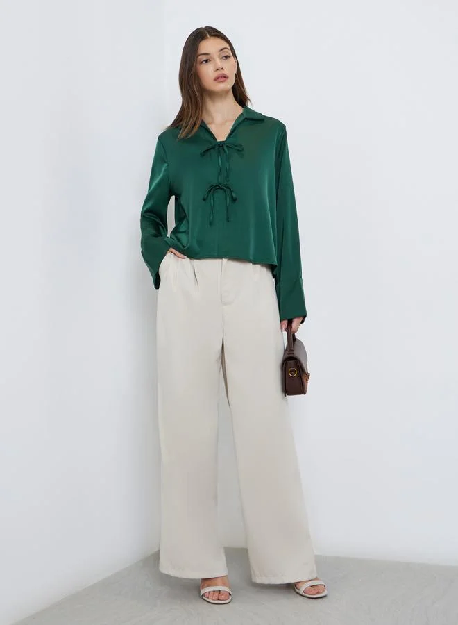 ستايلي بلوزة بتفاصيل ربطة أمامية