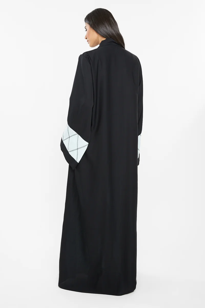 NUKHBAA A pastal blue abaya with square patterned embroidery detail.-AJ113A
