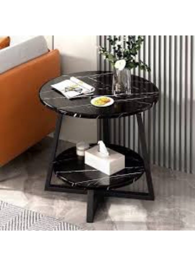 Modern round side table featuring a black marble finish top, a metal frame with a cruciform base, and a second storage shelf. - Image 1