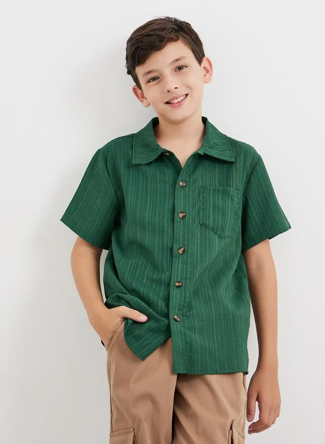 ستايلي قميص بتفاصيل بارزة الملمس مع أزرار