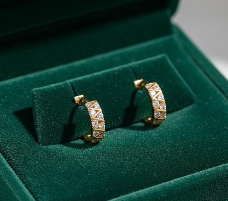 حلق ذهبي أنيق بتصميم الزيجزاج العصري، مرصع بفصوص زركون دائرية تمنحه لمعاناً استثنائياً. قطعة جريئة ومميزة تضفي لمسة من الحيوية والجمال على مظهرك. - Image 3