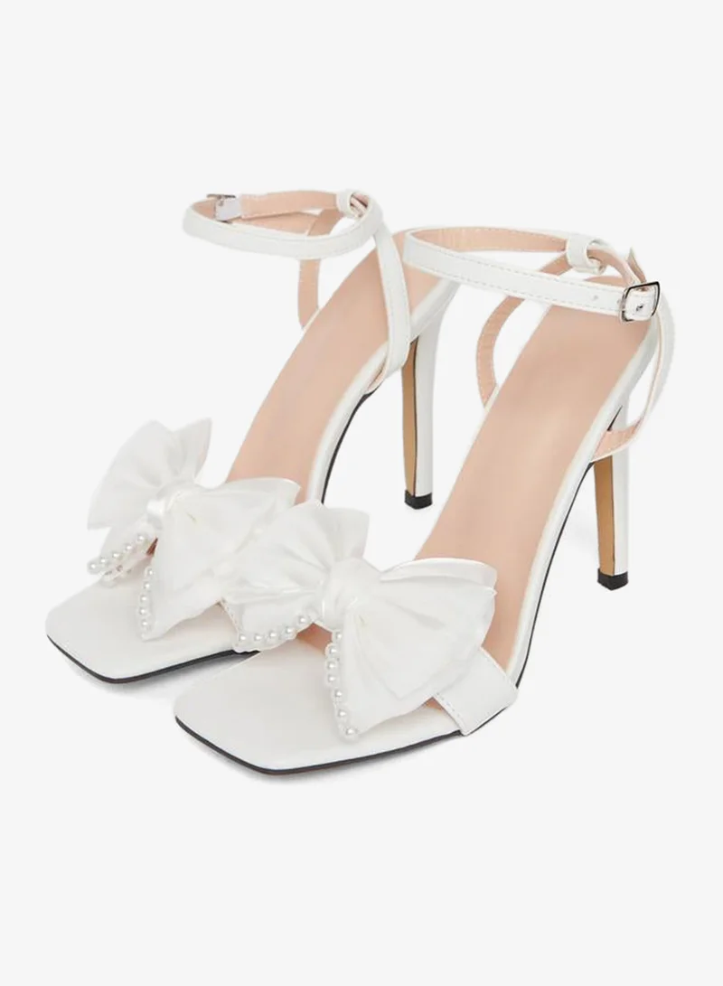 تايك تو صندل بكعب ستيليتو مزين بفيونكة ولؤلؤ