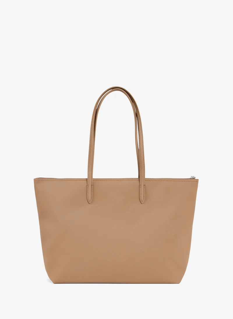 Lacoste The iconic L1212 style in a large shopping bag