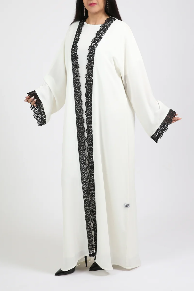 Nikias White nida abaya with inner and black lace on sleeves and front.delicate abaya for work and formal occasions.