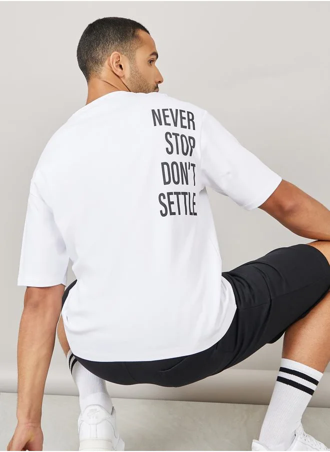 Styli Streetwear Front and Black Slogan Print Oversized Interlock T-Shirt