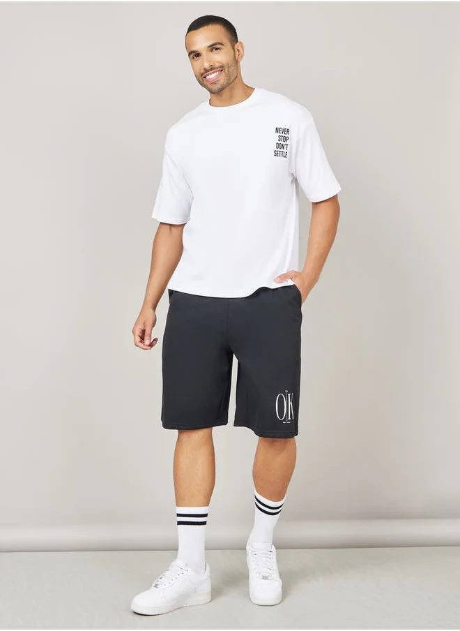 Styli Streetwear Front and Black Slogan Print Oversized Interlock T-Shirt