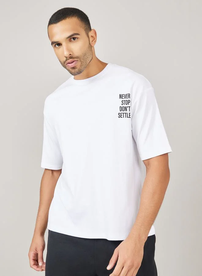 ستايلي Streetwear Front and Black Slogan Print Oversized Interlock T-Shirt