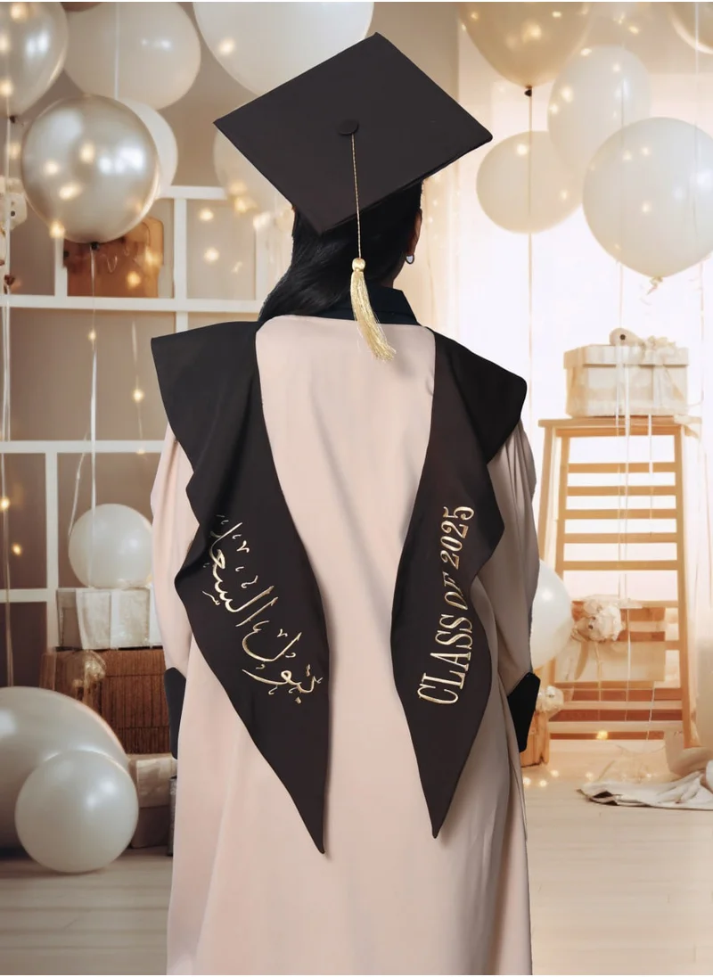 HAWRAA ABAYA Graduation outfit: a beige abaya with brown color inserts on the lining of the sleeves, with a scarf and a plain cap