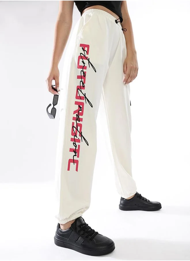 Hubberholme Women Track Pants in Off White featuring Jogger fit with a printed pattern, no sleeves, regular length, secured with elasicated + drawstring closure, crafted from terry – a trendsetting piece that blends fashion and comfort.