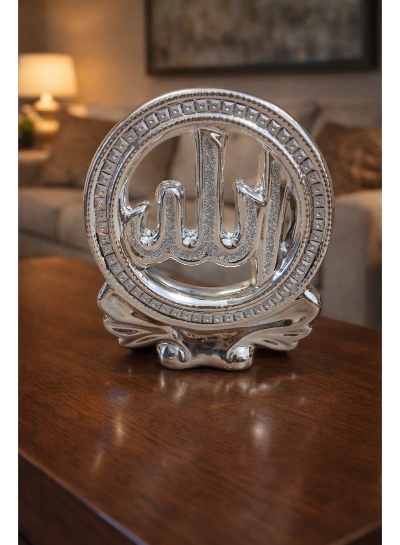 A breathtaking spiritual masterpiece featuring the sacred name of "Allah" enclosed in a sparkling circular frame. This metallic silver decor piece combines modern craftsmanship with traditional calligraphy, resting on an elegant, flowing base. - Image 3