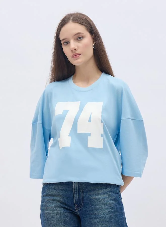 Styli Styli Women Light Blue Exaggerated Shoulder Graphic Oversized T-Shirt