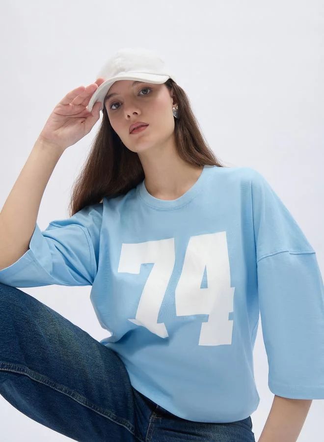 Styli Styli Women Light Blue Exaggerated Shoulder Graphic Oversized T-Shirt